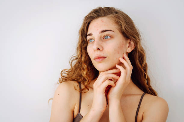 Portrait of a young woman with curly hair looking away thoughtfully