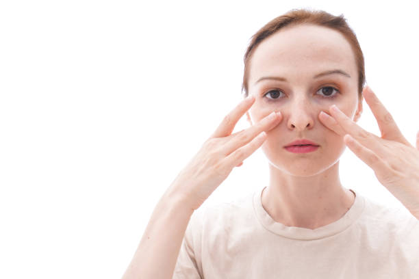 Woman performing facial yoga exercises